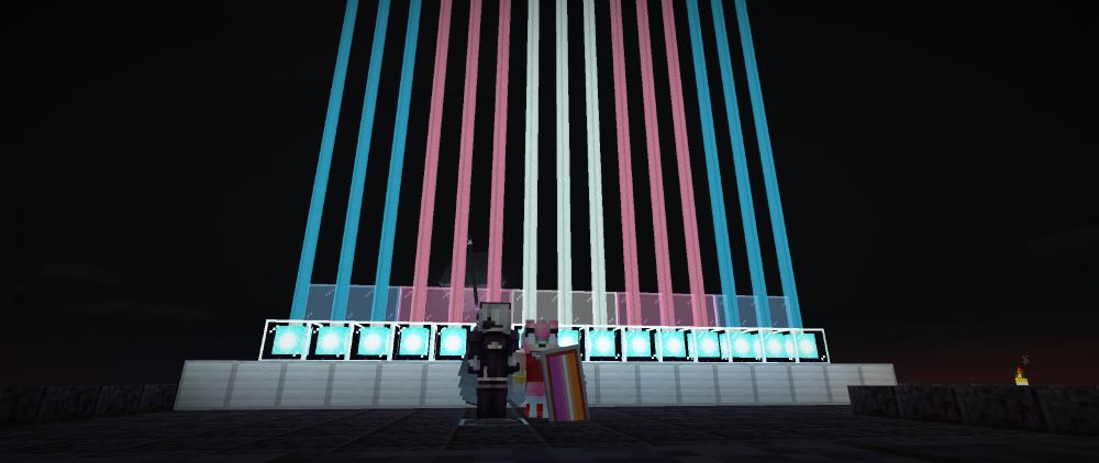 me and my friend standing in front of a trans flag coloured beacon in minecraft