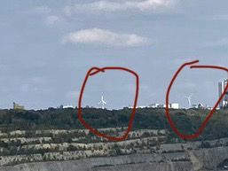 Two windmills away barely visible zoomed in and marked