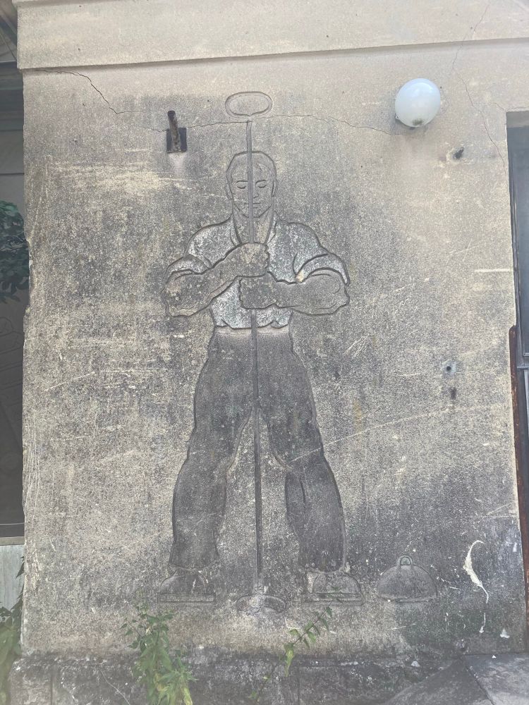 mural showing worker with pile