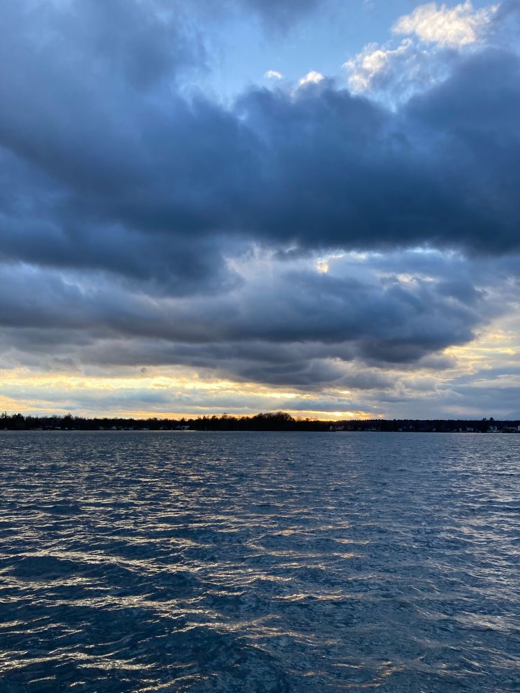 cloudy dark blueish sky over water 