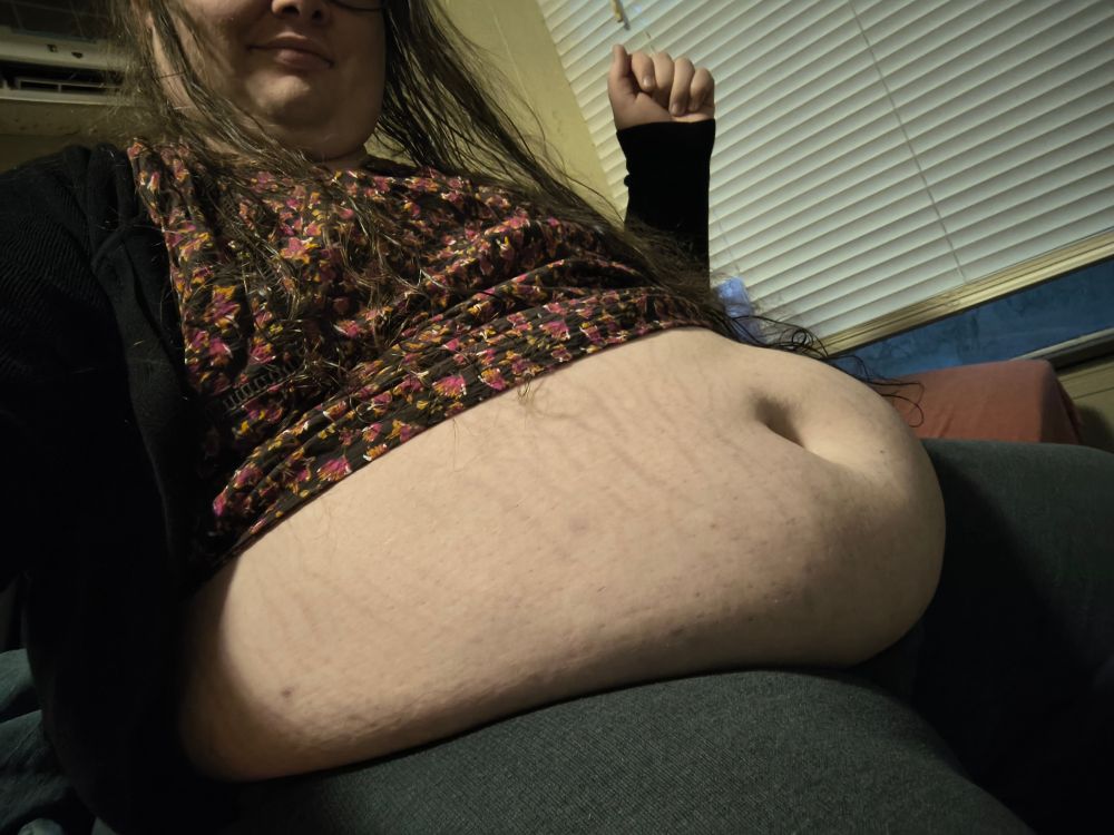 Before, sitting, shirt ridden halfway up.