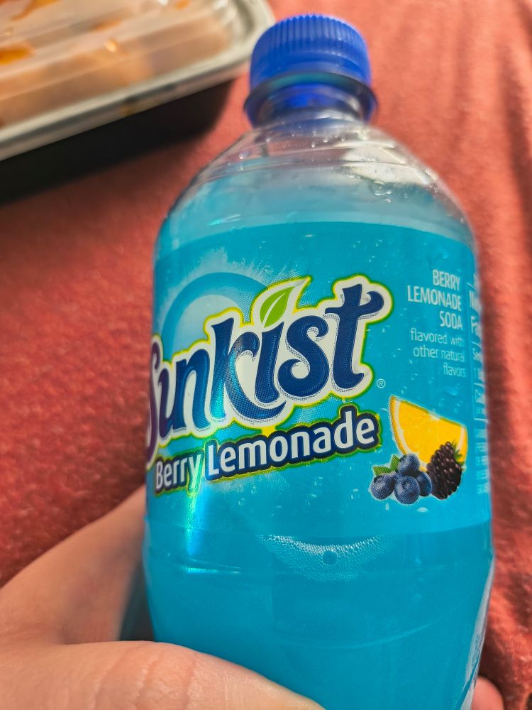 Sunkist soda bottle, the flavor reads berry lemonade. There are blueberries, a lemon wedge, and a blackberry on the label.