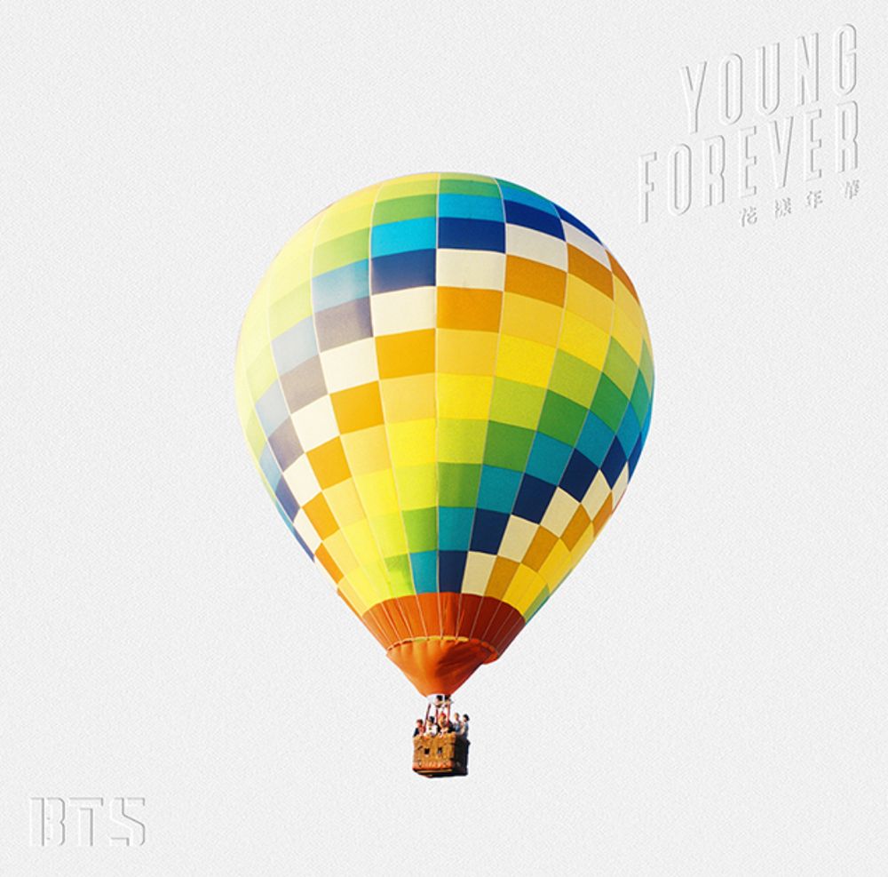 Album cover from BTS' The Most Beautiful Moment in Life: Young Forever. A hot air balloon in yellow, green, blue, orange and white rectangles is aloft with a gondola full of seven normal boys from Korea.