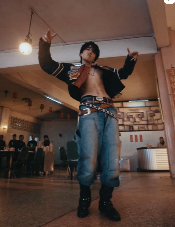 J-hope of BTS dances in his MV for new release Killin' It Girl. You won't believe it, but there's no shirt under his racing jacket, and 3 belts over his jeans, one of which actually says "Bait" on the buckle ... Hobi's all grown up!
