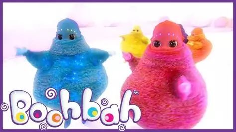 An image of the Boohbah, from the tv show of the same name. Boohbah are round fuzzy bipedal creatures with little bald humanoid heads with large dark eyes and eyebrows made up of dots that contain lights, and come in different colours (the 4 pictured are blue, pink, yellow, and orange respectively) 