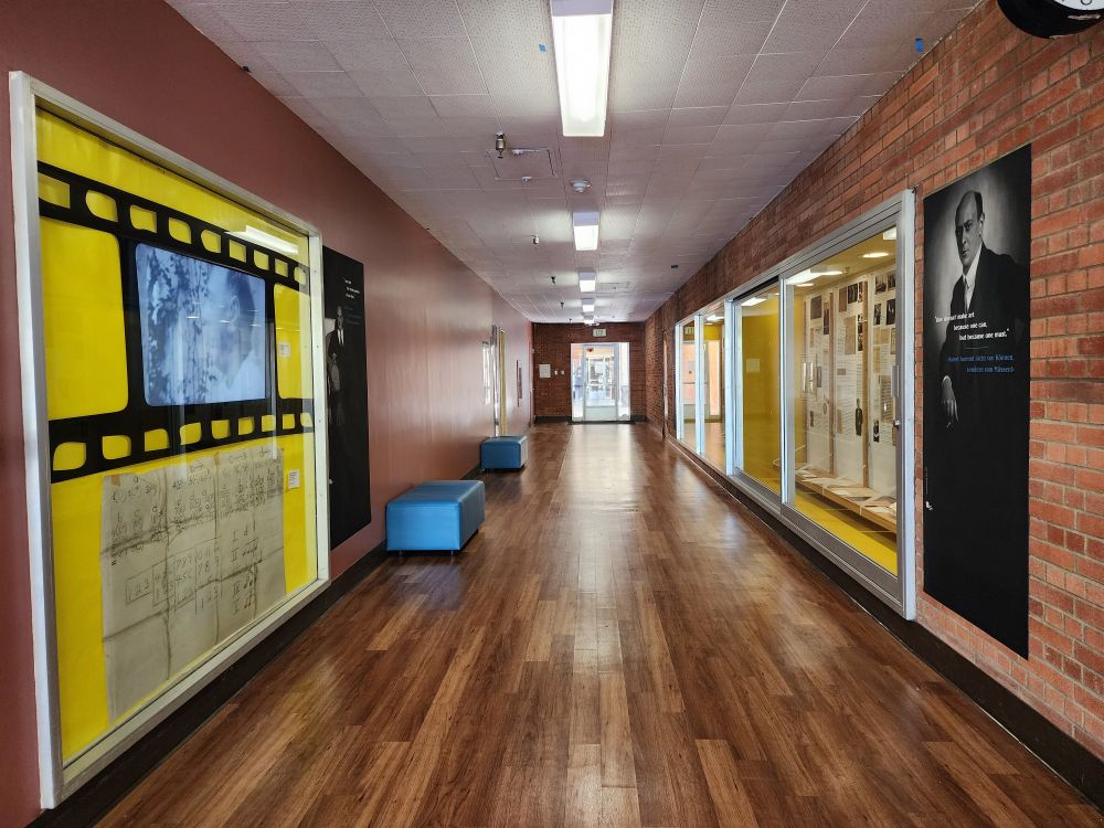 A hallway with exhibition cases on the left and right