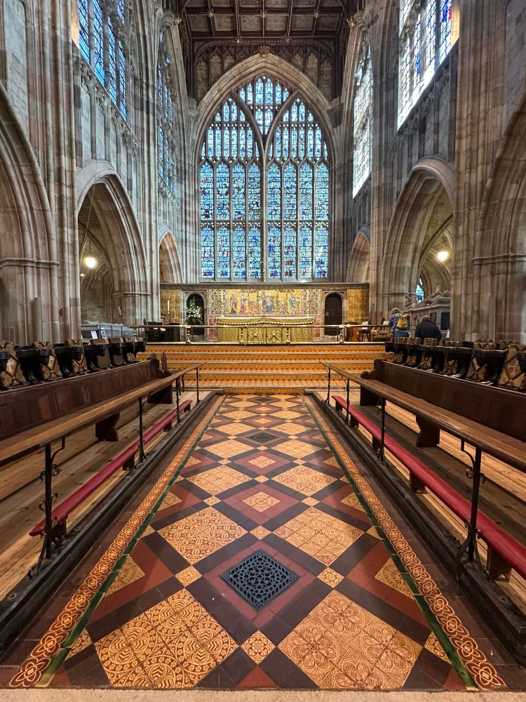 Victorian floor tiles in the chancel, looking towards the altar & the east window.