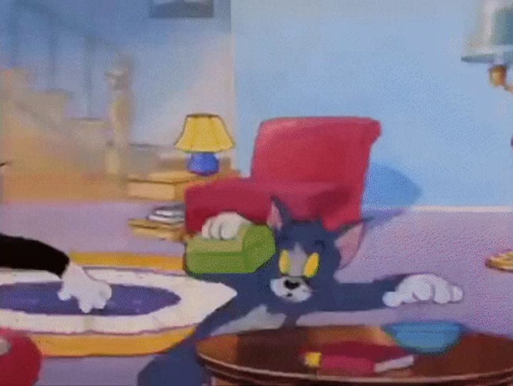 a cartoon of tom and jerry in a living room with a table and chairs