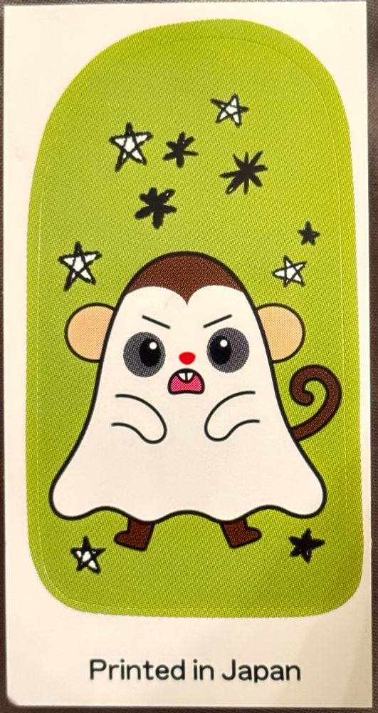 Sticker with a sheet ghost monkey and cartoon stars on a green background 