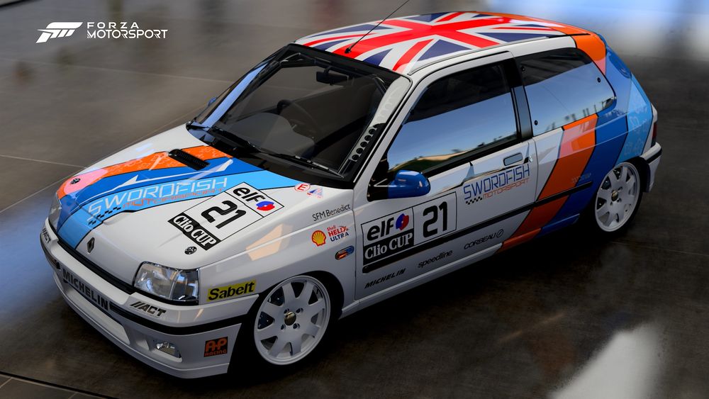 a 1993 Renault Clio Williams with a Swordfish Motorsport livery! The base color is white, with orange, light blue and medium blue stripes adorning the rear of the quarter panel and across the hood.

It has the #21, the UK flag on the roof and medium blue mirror covers