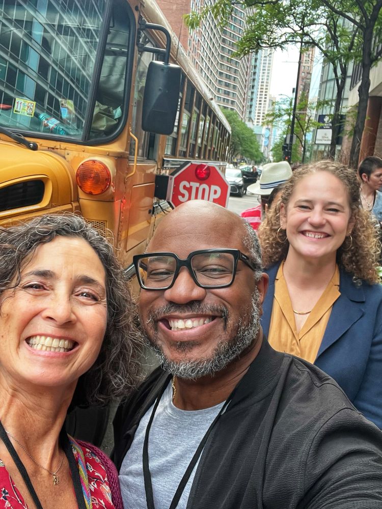 Three political scientists about to board a school bus on a Chicago city street