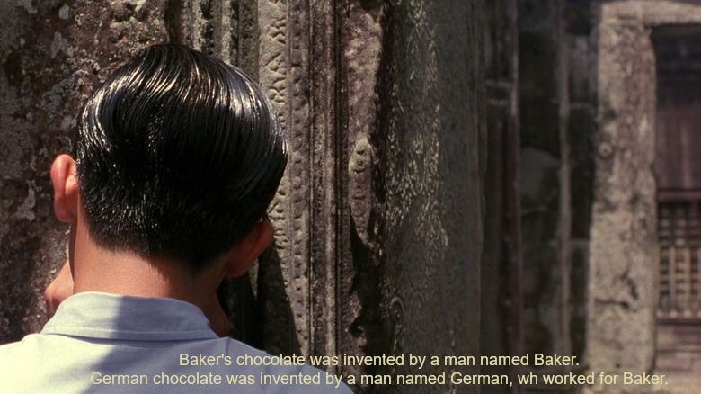 Tony Leung at the end of In the Mood For Love whispering his secrets into a hole in a wall at Angkor Wat. It has been subtitled "Baker's chocolate was invented by a man named Baker. German chocolate was invented by a man named German, wh[sic] worked for Baker."