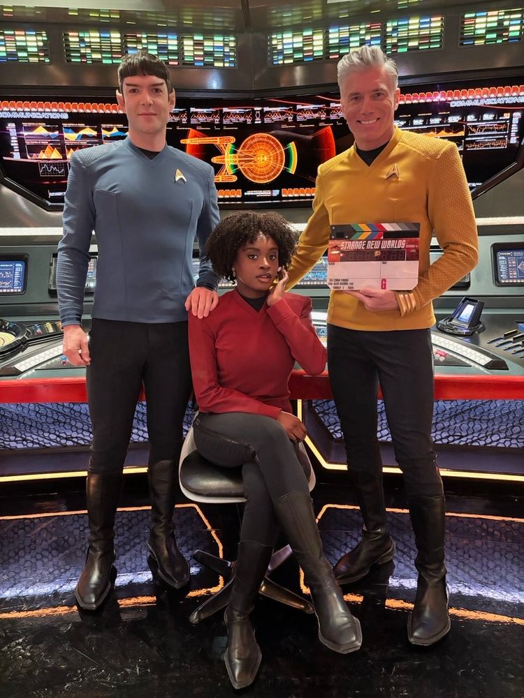Photo of the Enterprise crew (Spock, Uhura, Pike) celebrating the start of production on Strange New Worlds season 4. 