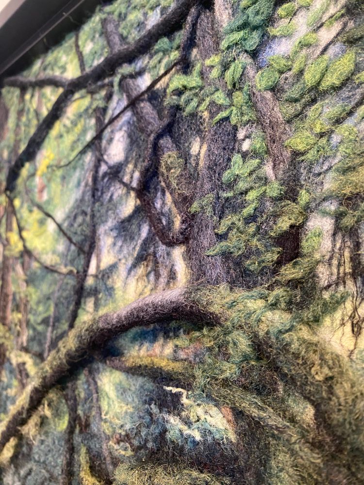 Detail of needlefelted wall sculpture of an image of the forest. 
