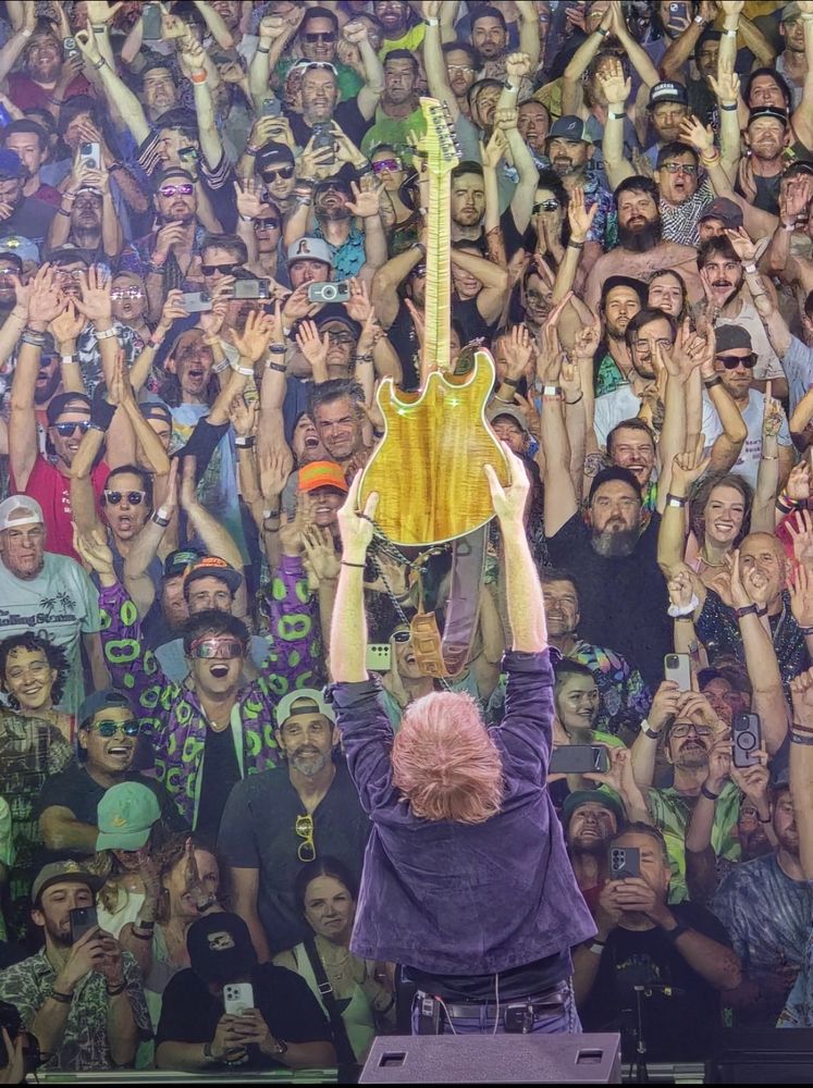 Photo of Trey Anastasio and the crowd’s reaction as he raised his guitar at the end of “First Tube”