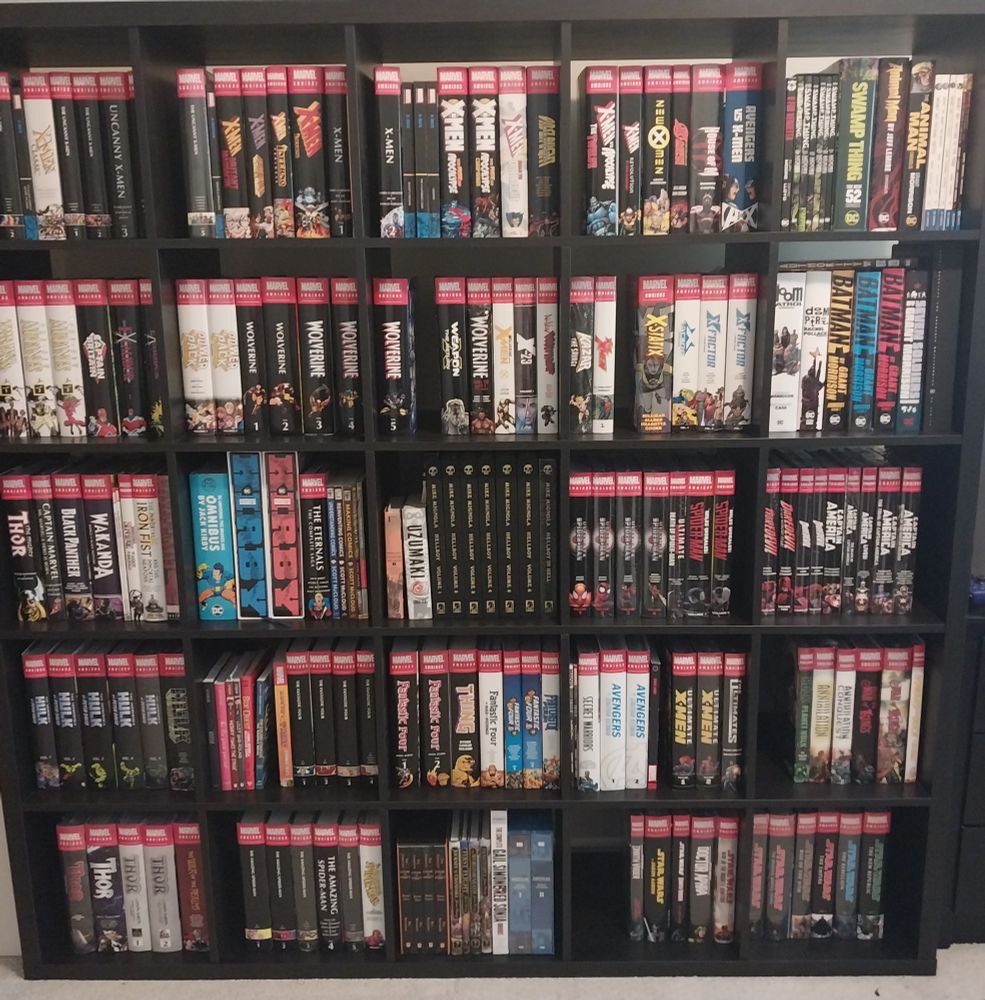 A big cube-based shelf system filled with comic book omnibus editions
