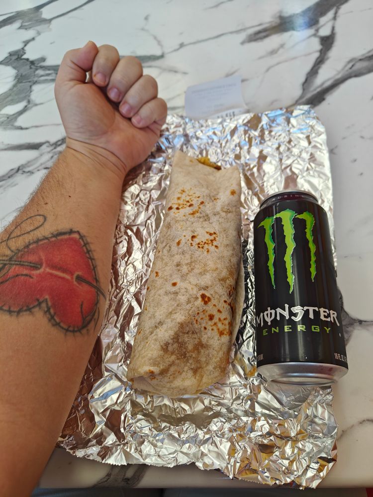 My forearm, a large burrito, and a can of monster in decreasing lengths 
