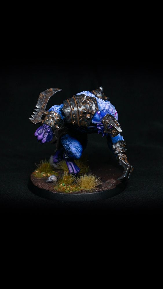 A Skaven Rat Ogor miniature from Warhammer Age of Sigmar. These Ogre sized rat mutants have been given a palish blue paint job, with rusty armor and purple hands, feet, and head. Rat Ogor 2