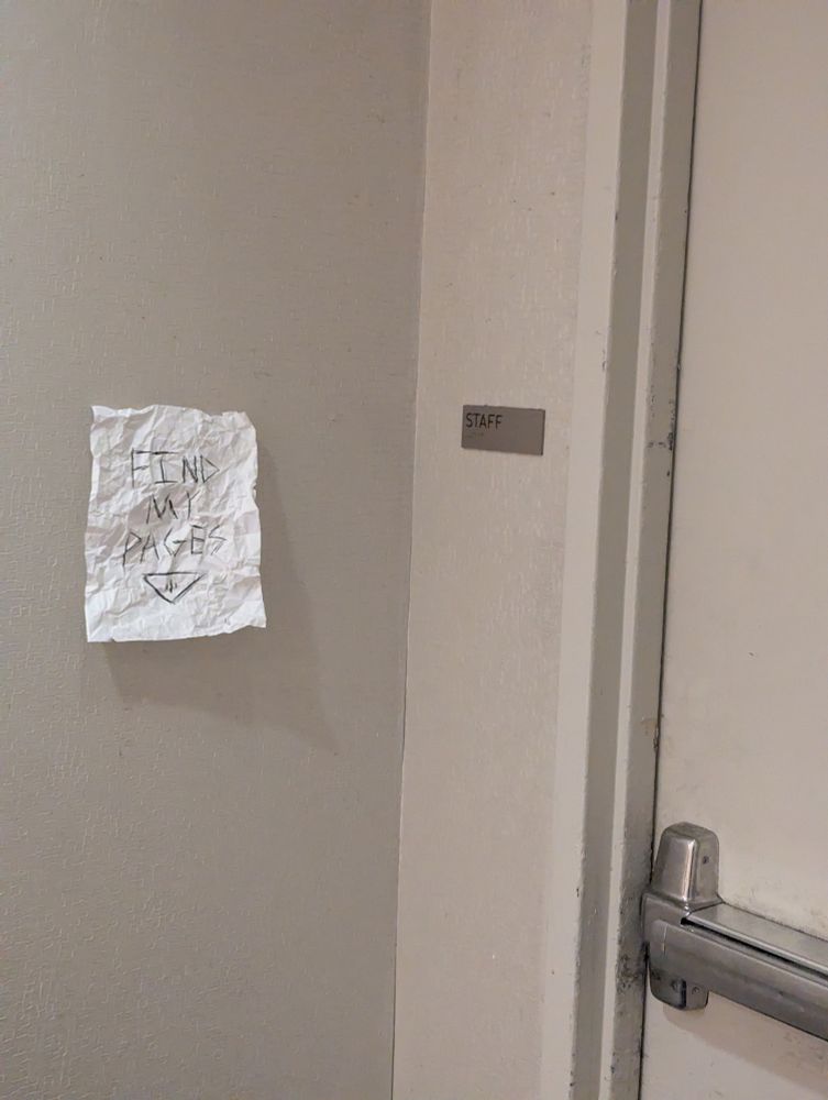 A staff door in the lobby of the Hyatt Regency O'Hare with a Slenderman-esque piece of paper next to it that says "find my pages" 