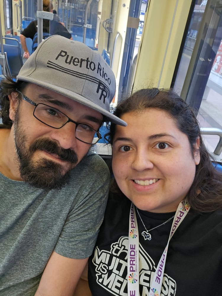 Peter and Jenna sitting together on the train 