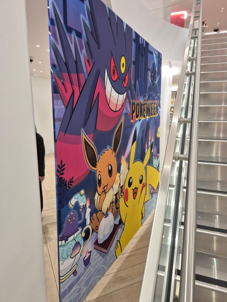 The opposite side of the backdrop, featuring the Pokéween logo with Pikachu, Eeves, Sinistea, Ceruledge and Mega Gengar.