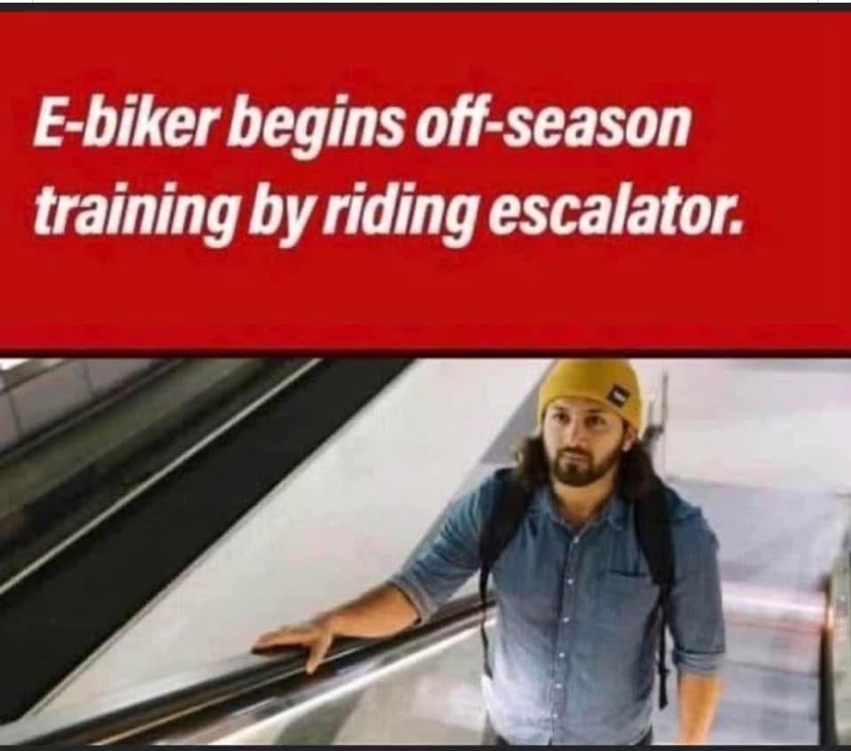 Man riding up escalator