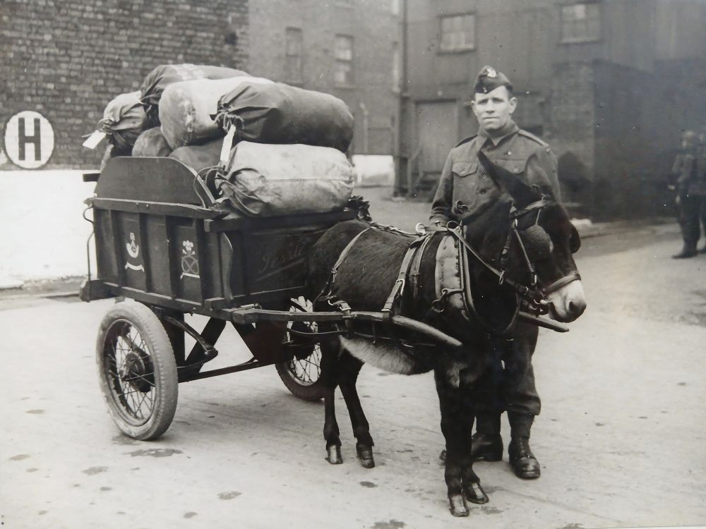 Black and white photograph of Jessie and Private Ellis at the Flaxmill Maltings, Shrewsbury, 1942, with soldier’s kit bags to be taken to Shrewsbury Railway Station.