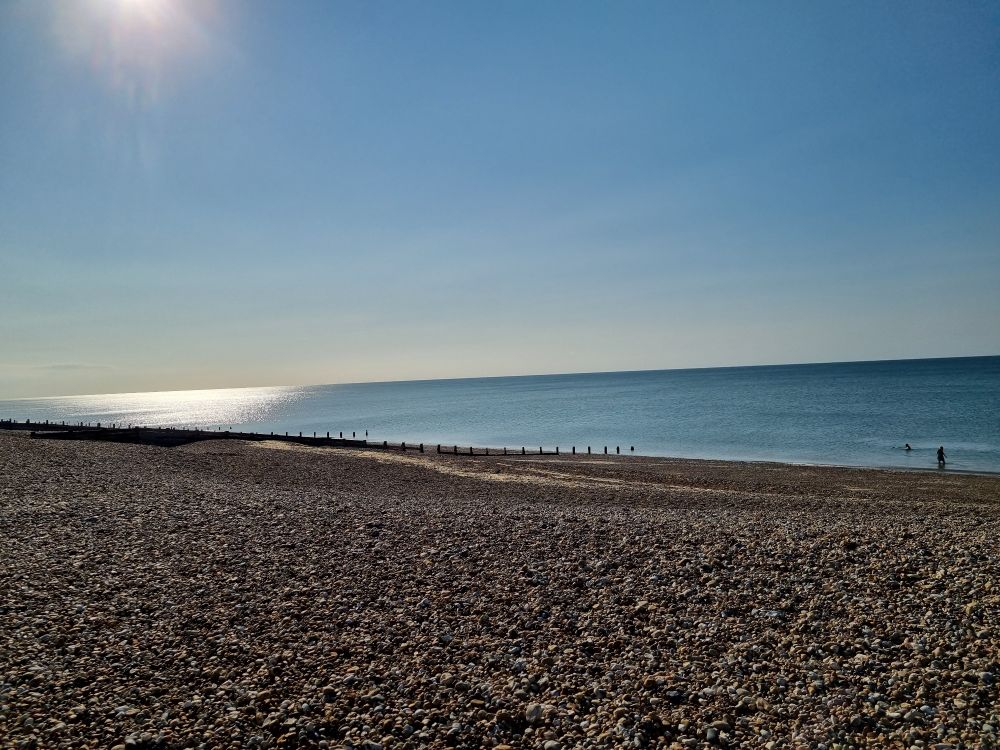 An empty stony beach on a sunny morning.
