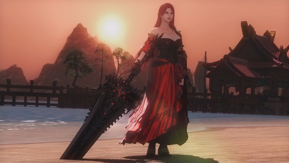 Elise Solara, a red-haired freckled woman standing on a beach, holding a greatsword embedded in the ground. The sun is setting behind her as she gives a slight smile into the camera.