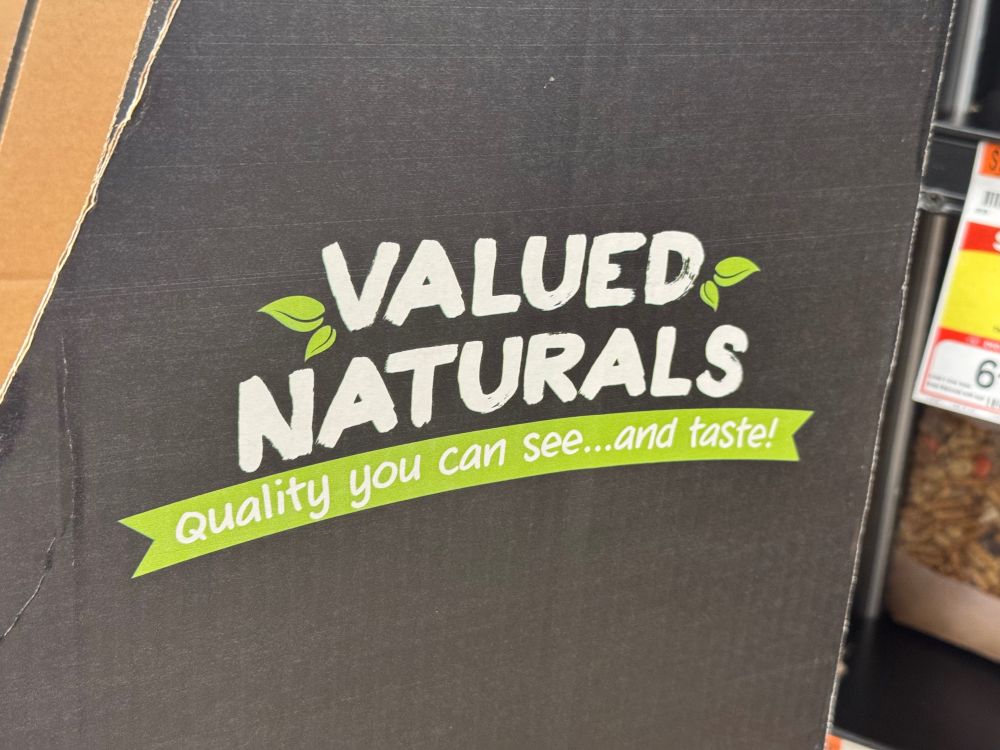 Grocery store signage for a brand called “valued naturals”