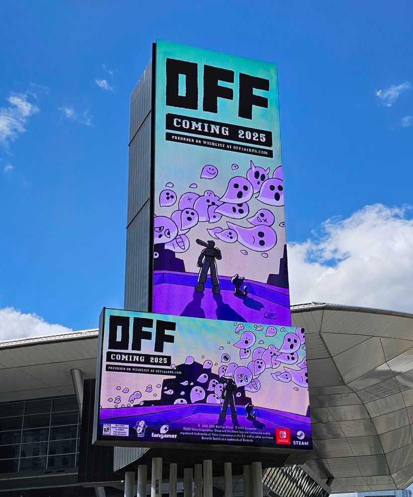 A giant LCD vertical and horizontal billboard featuring OFF promotional art is in front of a chrome convention center and a bright, blue sky. The art on the billboard is a graphic featuring the game poster art for OFF: The Batter and the Judge standing on a purple building watching white ghosts float by against a light green sky near the text "OFF, Coming 2025”
