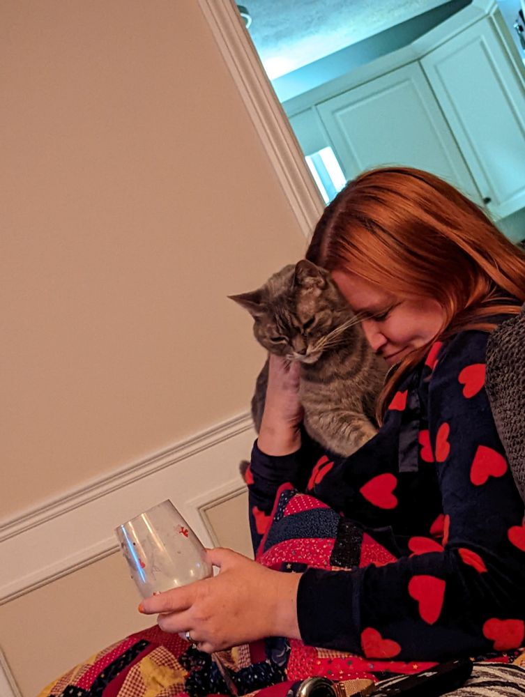 Kiki the cat snuggles with my wife Jennifer, the week we moved into our new home November 2022