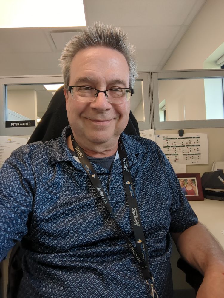 Pete, at his desk in the Vital Statistics department of Service New Brunswick 