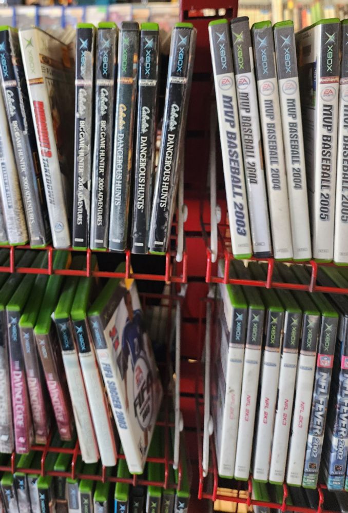 Original Xbox game spines, sun-bleached to oblivion. 