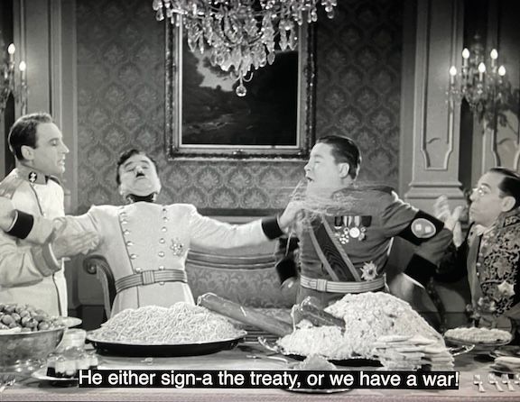 
Napaloni shouts at Hynkel, "He either sign-a the treaty, or we have a war!"