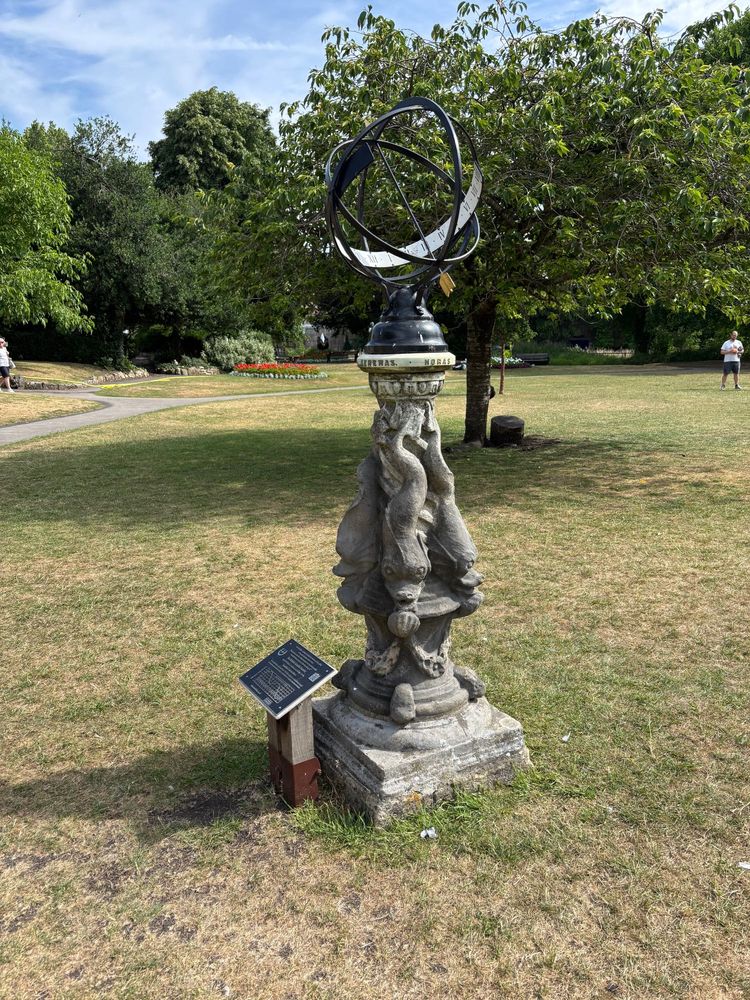 A sundial made out of an armillary sphere, with an arrow as the gnomon
