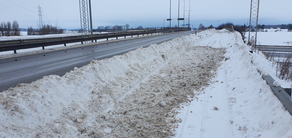 Snow ploughed from the road onto the cycle path.