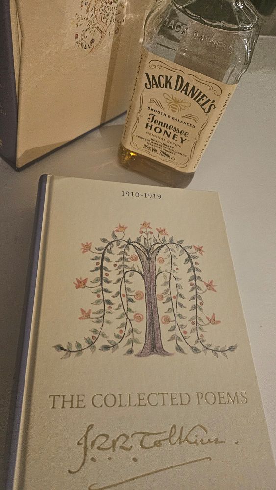 A picture with "The Collected Powms of J.R.R. Tolkien" and a bottle of Jack Daniel's Honey Liqueur.