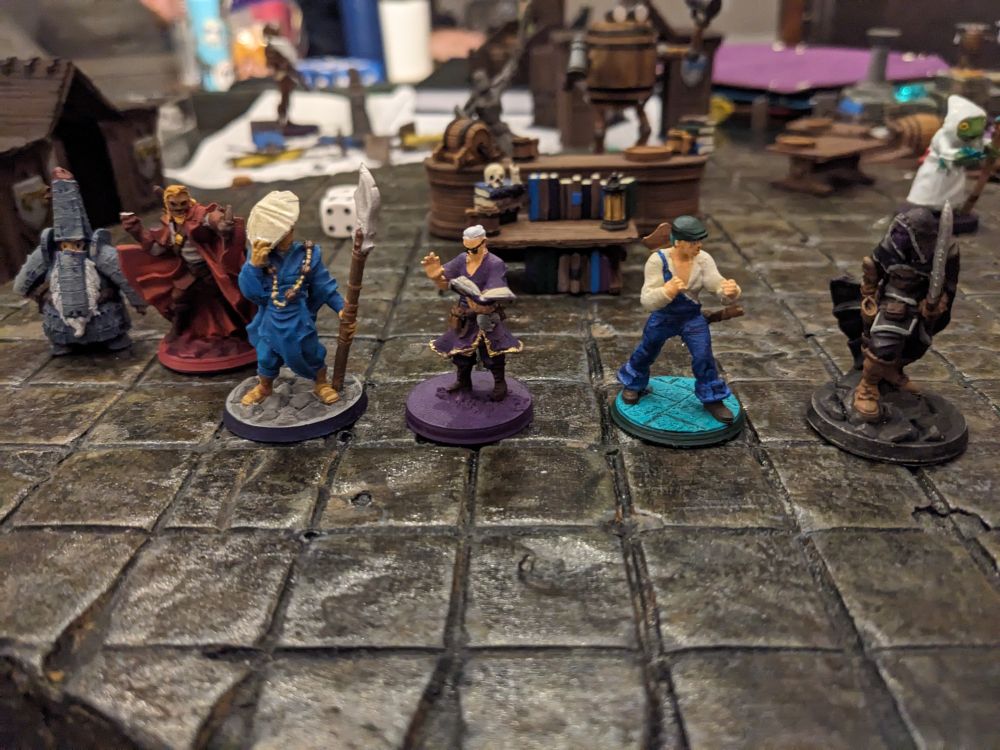 Mini figures of a various heroes in front of a book shelf.