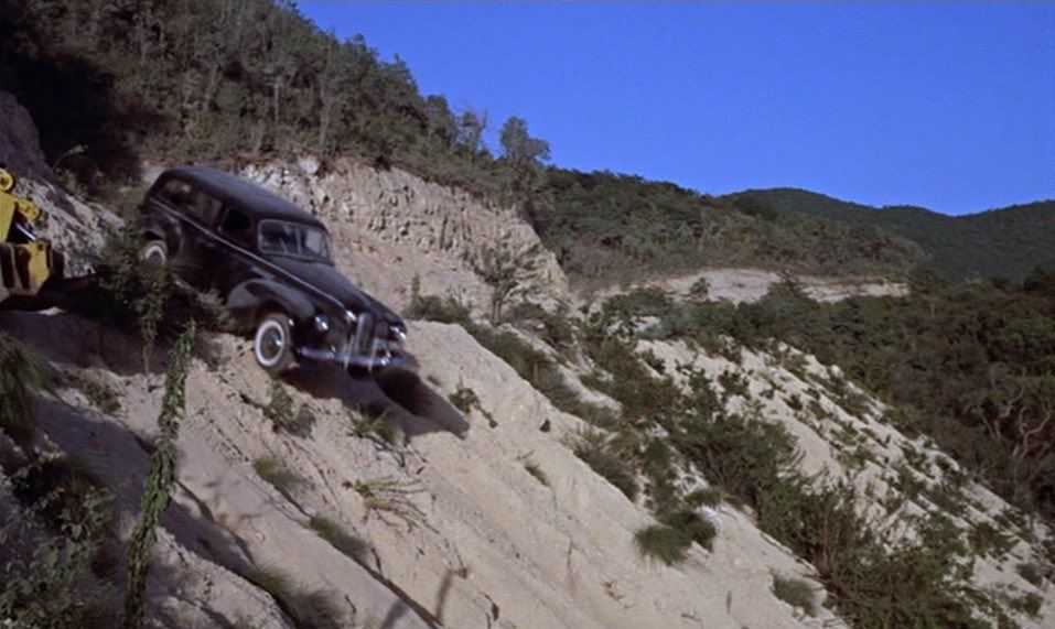 A black hearse going over a cliff
