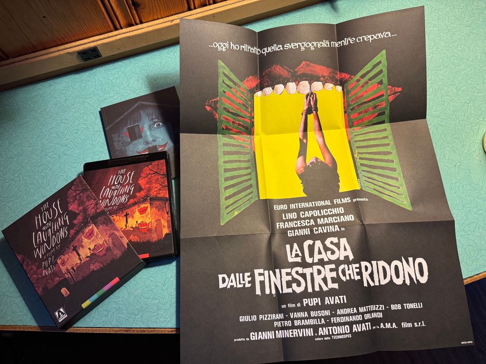 A Blu-ray set for the house with laughing windows, including a book, slip case, and a poster