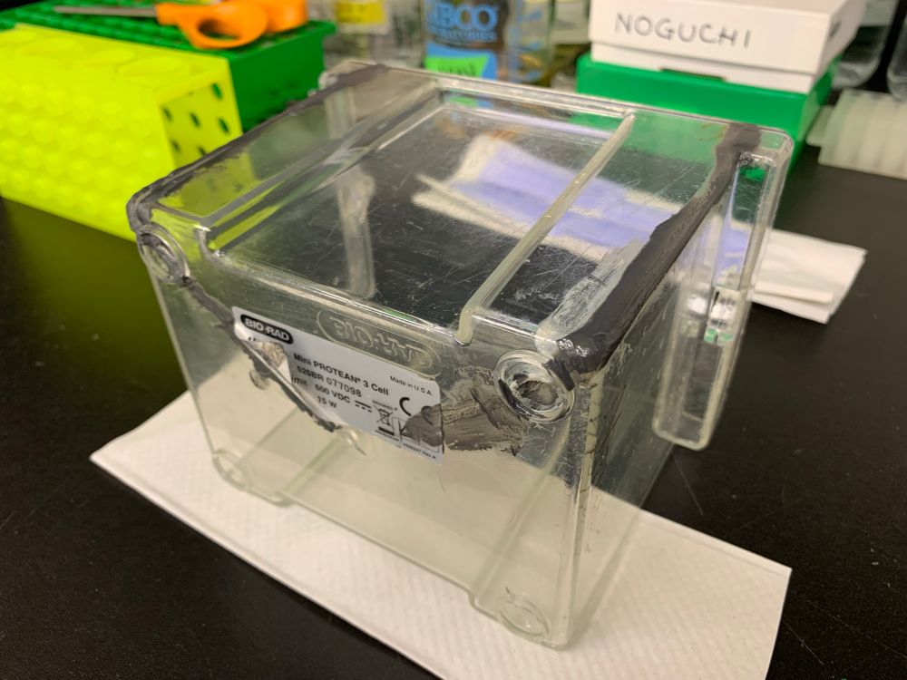 A transparent plastic container with glue on it is found on a research station.