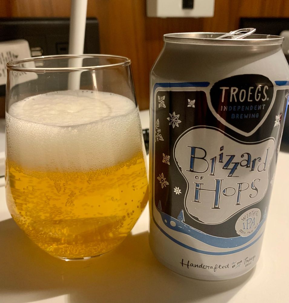 Tröegs Bizzard of Hops Winter IPA  on a white bedside table.