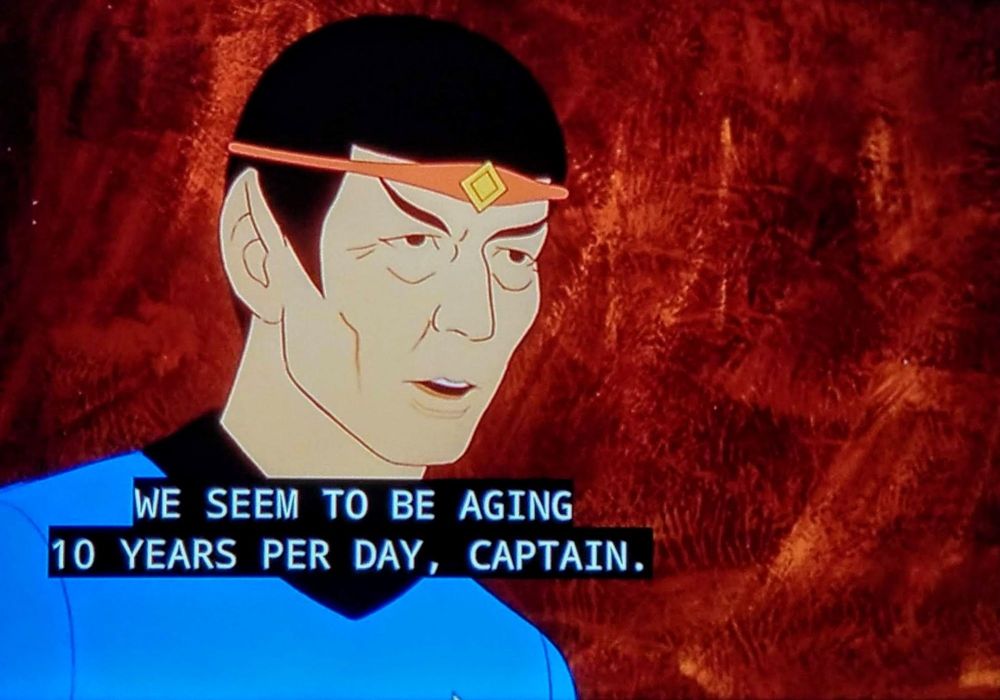 A screen grab from Star Trek: The Animated Series, wherein a visibly aged Spock wearing some sort of circlet is saying, "We seem to be aging 10 years per day, Captain." 