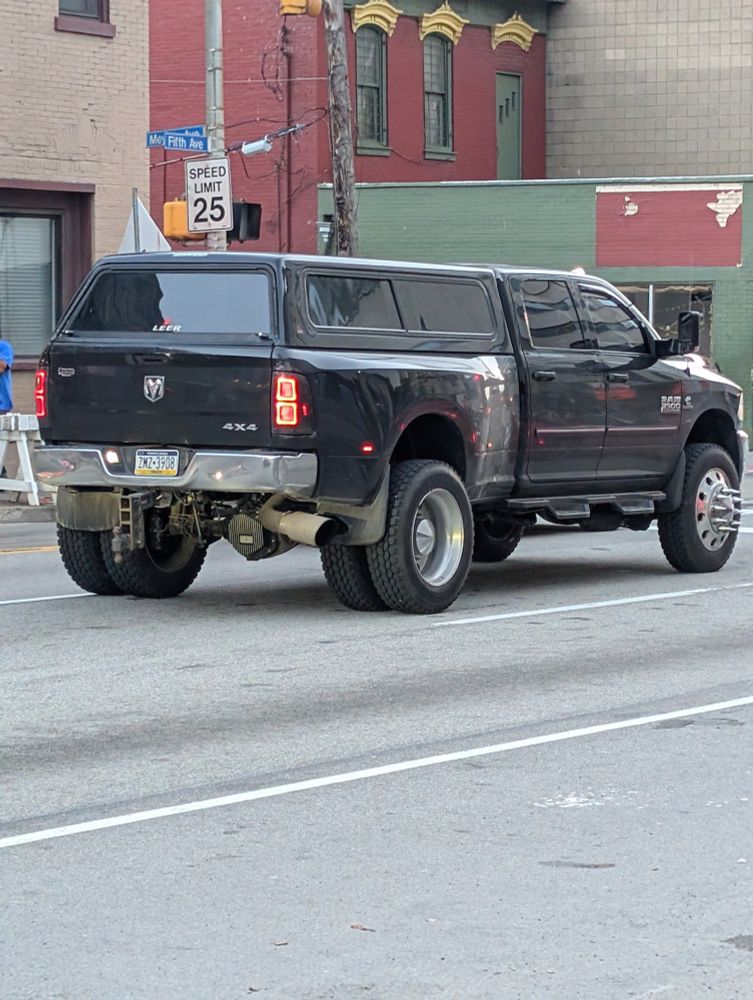 Big-ass lifted RAM 3500 4×4 with 6 tires. 