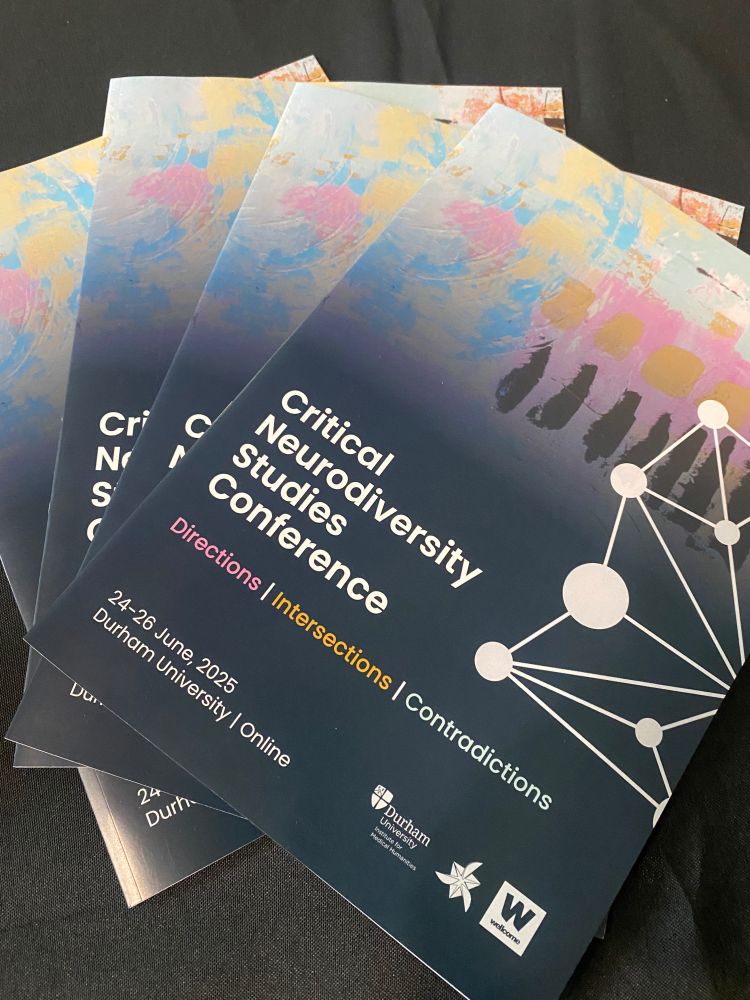 A fan arrangement of conference programmes with abstract artwork in pink, orange, light blue and black. On the right there are white circles connected with white lines. The title on the programme reads: 'Critical Neurodiversity Studies Conference: Directions / Intersections / Contradictions, 24–26 June 2025, Durham University and Online.' 