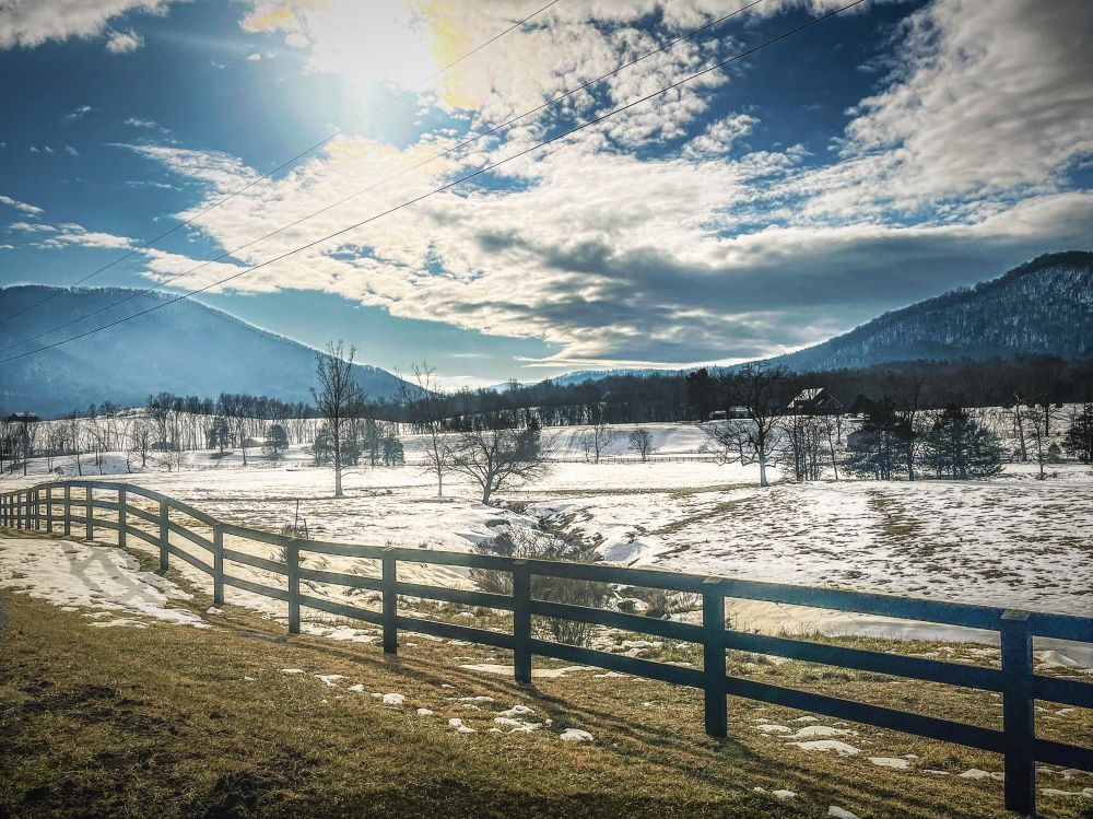 View of mountains, a bright sun, and ice. 