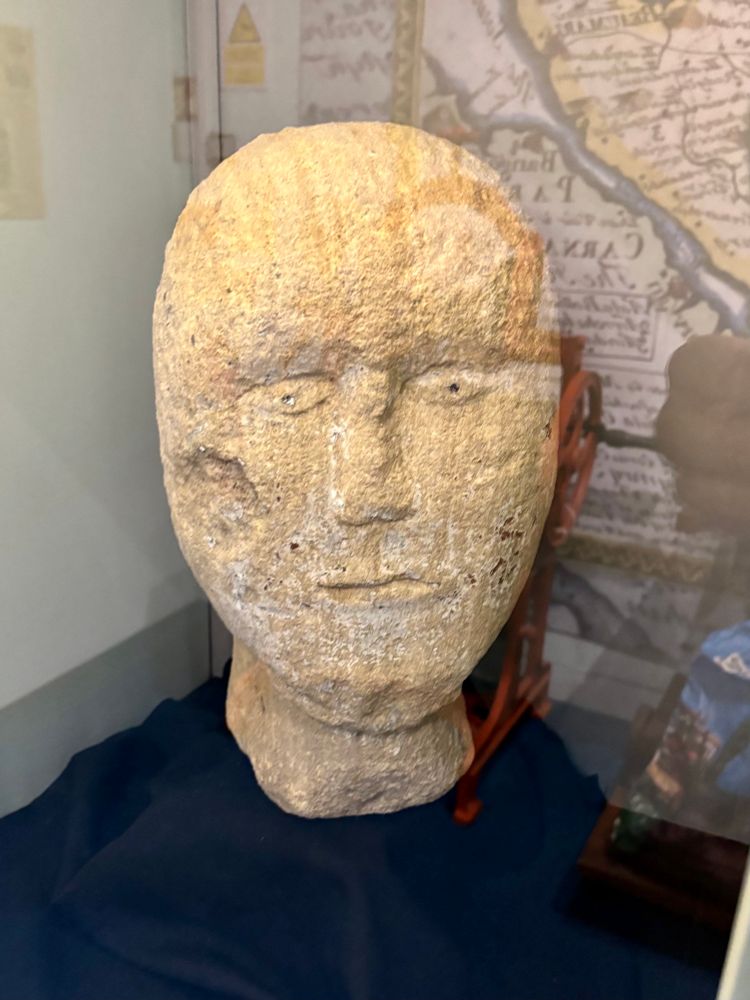 Human head carved from sandstone.