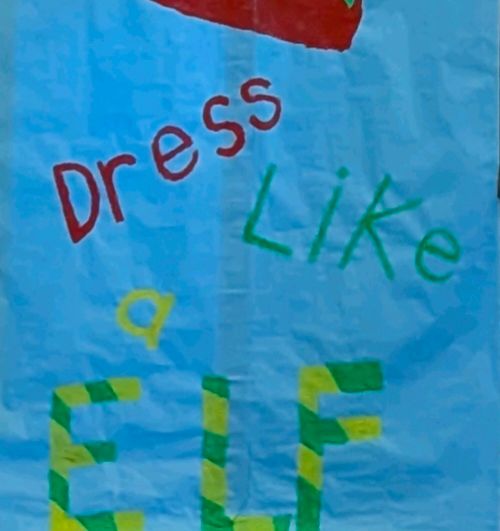 Poster from my job that reads "dress like a elf" 
