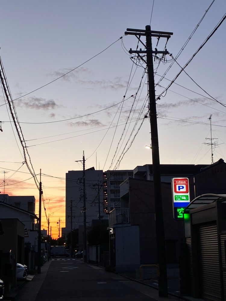 Sun setting between buildings 